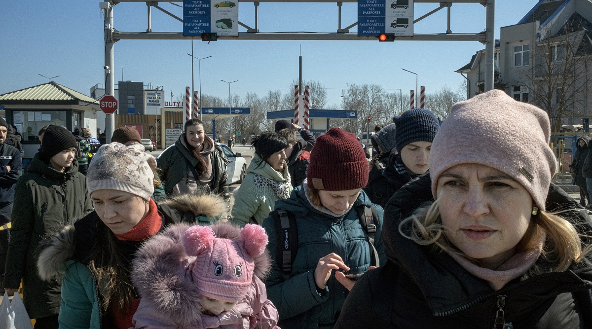 File photo of people who fled the fighting in Ukraine wait for buses after crossing the border into Palanca, Moldova. (Mauricio Lima/The New York Times)