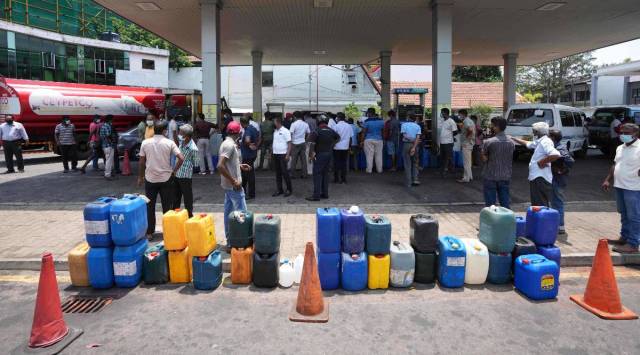 Sri Lankans gather at a fuel pump with empty containers to buy diesel in Colombo. (AP)