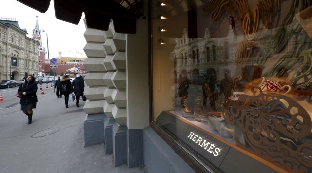 People walk past a Hermes shop window in Russia's landmark GUM shopping centre on the Red Square in Moscow, Russia. (Source: Reuters)