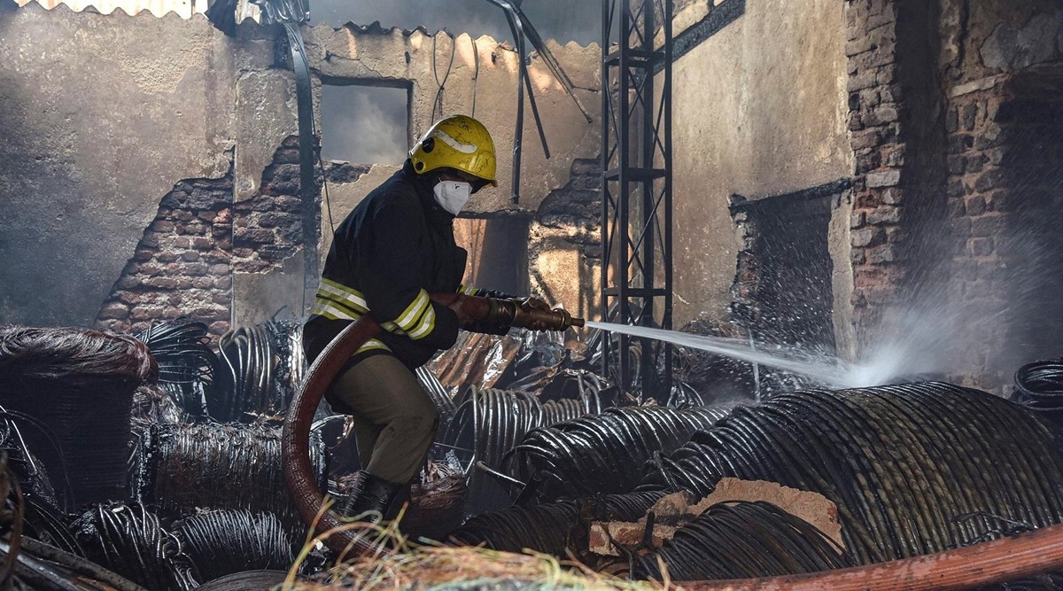 A firefighter tries to douse the flames after a fire broke out at a scrap godown in Secunderabad Wednesday (PTI)