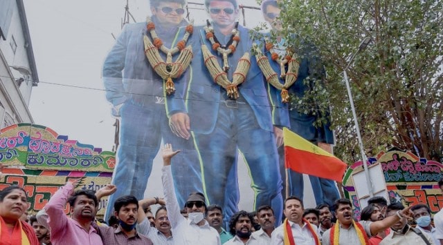 Pro-Kannada organisations protesting outside Trivendi theatre in Bengaluru against the alleged forced removal of late actor Puneeth Rajkumar's movie 'James'. (Express photo by Jithendra M)
