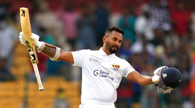 Sri Lanka's captain Dimuth Karunaratne celebrates scoring a century during the third day of the second cricket test match between India and Sri Lanka in Bengaluru, India, Monday, March 14, 2022. (AP Photo/Aijaz Rahi)