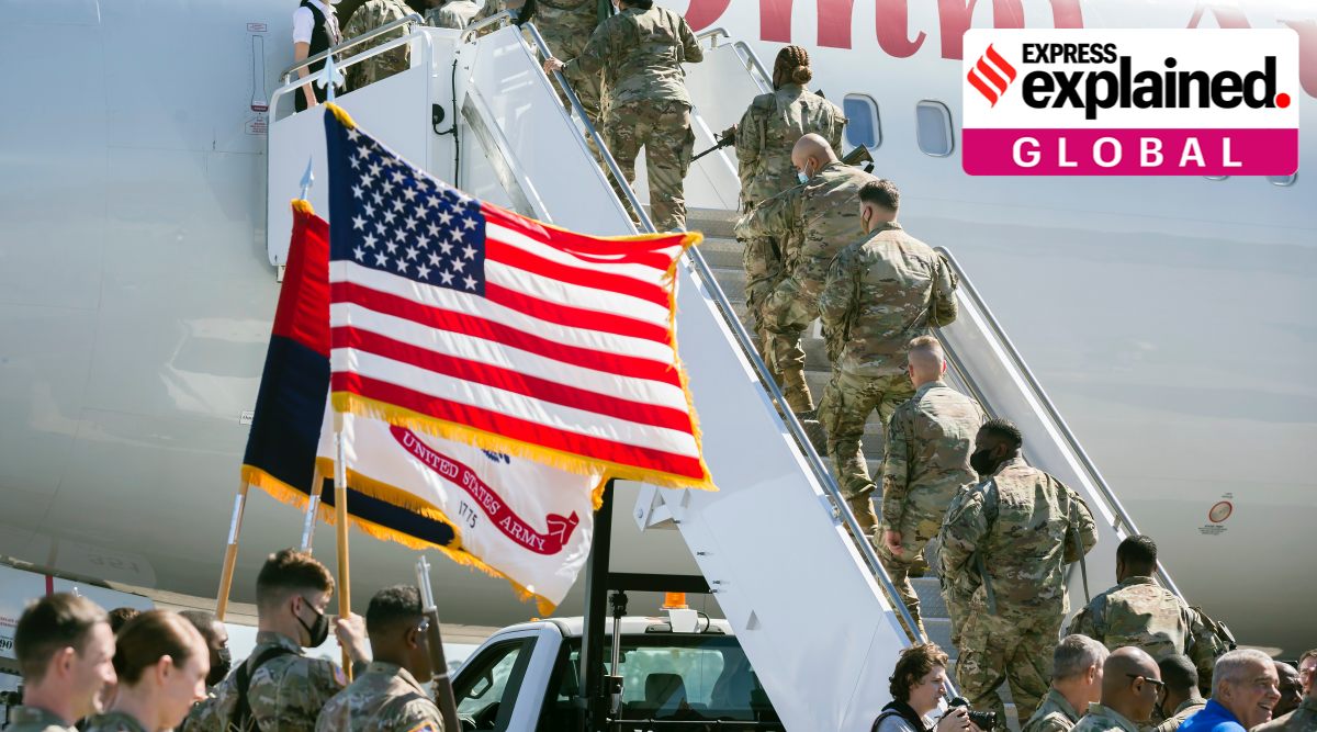 US soldiers climb the stairs to a charter airplane at Hunter Army Airfield during their deployment to Germany, Wednesday March 2, 2022 in Savannah, Ga. (Stephen B. Morton /Atlanta Journal-Constitution via AP)


