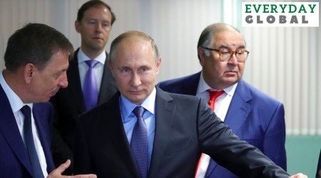 Russian President Vladimir Putin, center, listens to Lebedinsky GOK Managing Director Oleg Mikhailov, left, as businessman Alisher Usmanov, right, and Minister of Industry and Trade Denis Manturov stand behind him while visiting the Lebedinsky GOK JSC, in Gubkin, Belgorod Region, Russia. (AP/File)