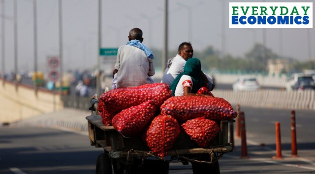 A vegetable seller carries onions to sell in New Delhi. (Express Photo: Praveen Khanna)