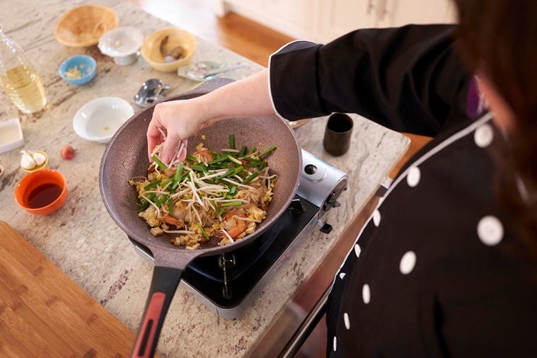 Watcharee Limanon, a cooking teacher, makes pad Thai in Yarmouth, Maine, on March 15, 2022. (Dennis Welsh/The New York Times)