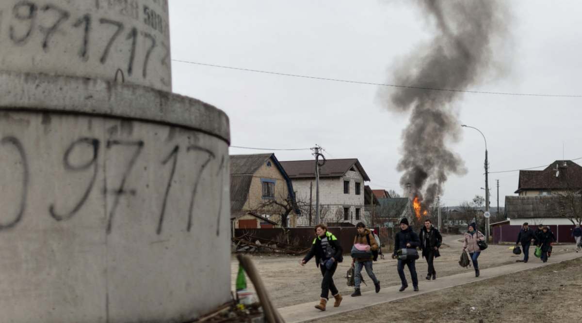 Local residents look for cover as they escape from the town of Irpin, after heavy shelling on the only escape route used by locals, while Russian troops advance towards the capital of Kyiv, in Irpin, near Kyiv, Ukraine March 6, 2022. (Photo: REUTERS)