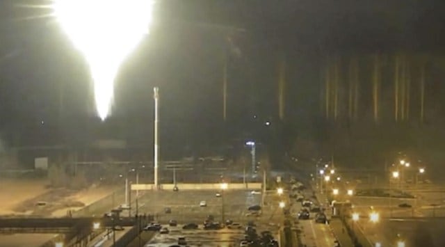 This image made from a video released by Zaporizhzhia nuclear power plant shows bright flaring object landing in grounds of the nuclear plant in Enerhodar, Ukraine Friday, March 4, 2022. (AP)
