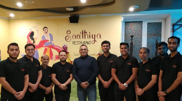 Manish Dave (centre, in blue) and the staff at Saaithya restaurant were among the last of Indians to leave Kyiv.