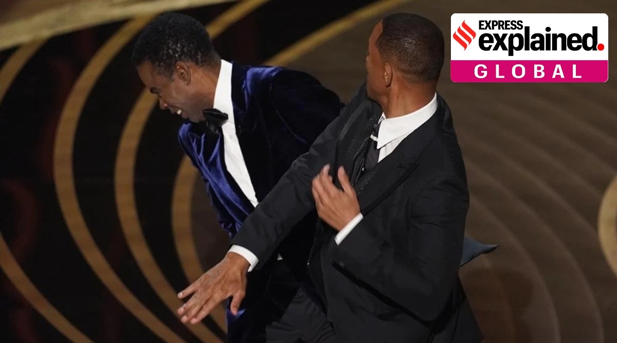 Will Smith (right) hits presenter Chris Rock on stage while presenting the award for best documentary feature at the Oscars on March 27, 2022, at the Dolby Theatre in Los Angeles. (AP, file)