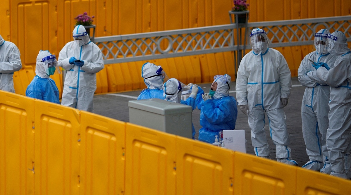 Policemen and staff workers get tested for the coronavirus disease at a makeshift nucleic acid testing centre inside barriers of an area under lockdown amid the Covid-19 pandemic, in Shanghai, China March 24, 2022. (Reuters)