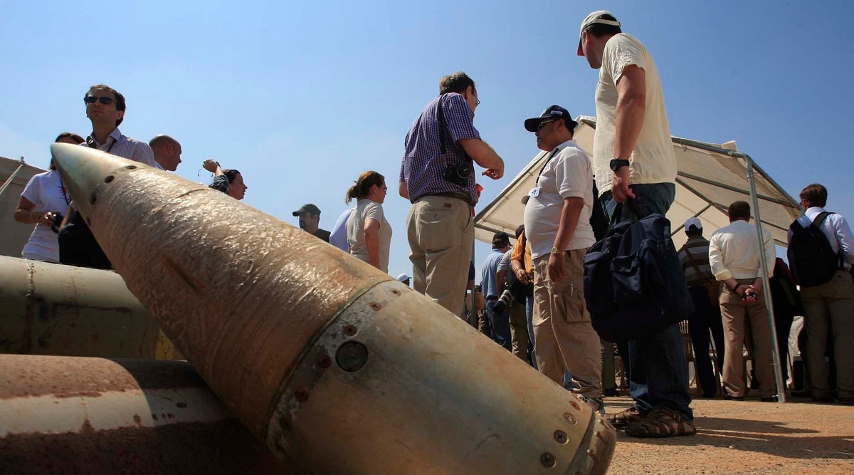 File photo of activists and international delegations standing next to cluster bomb units at a Lebanese military base. (AP)