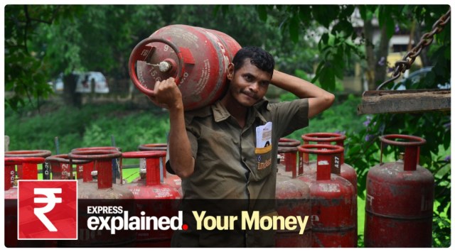 An employee of a gas agency carries a LPG cylinder to be distributed among the people. (Express Photo/File)