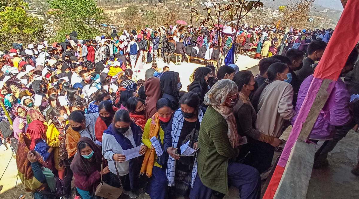 Voters wait in queues to cast their votes at a polling booth. (PTI Photo)