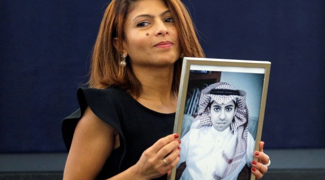 Ensaf Haidar, the wife of jailed Saudi Arabian blogger Raif Badawi, poses with a portrait of her husband (File/Reuters)
