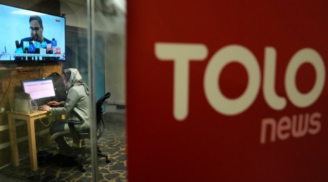 Afghan journalist Wheeda Hassan works on her desk at TOLO TV newsroom, in Kabul, Afghanistan, Tuesday, Feb 8, 2022. (AP Photo/Hussein Malla)