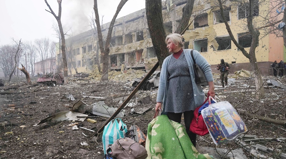 A woman walks outside a maternity hospital that was damaged by shelling in Mariupol, Ukraine. (AP, File)