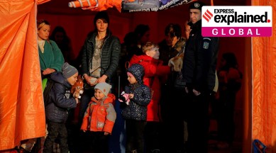 Refugees fleeing the war from neighbouring Ukraine stand in a tent after crossing the border by ferry at the Isaccea-Orlivka border crossing in Romania (AP /Andreea Alexandru)
