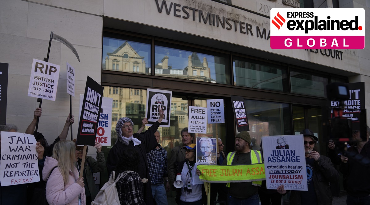 Wikileaks founder Julian Assange supporters hold placards as they gather outside Westminster Magistrates court In London on Wednesday. (Photo: AP)