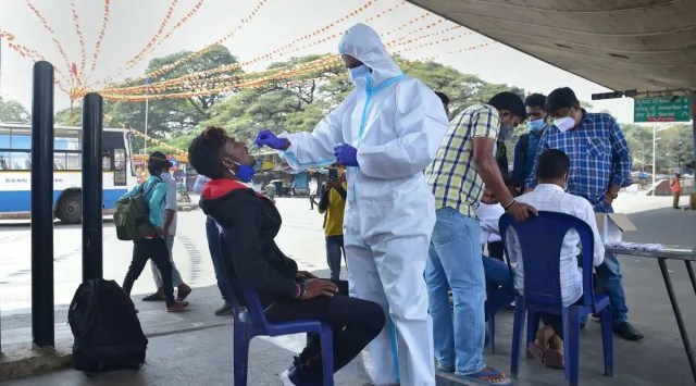 A health worker collects swab sample of a person for Covid-19 test in Bengaluru. (PTI)
