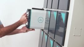 RACEnergy battery swapping: a picture of a battery pack being inserted into a battery storage system