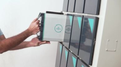 RACEnergy battery swapping: a picture of a battery pack being inserted into a battery storage system