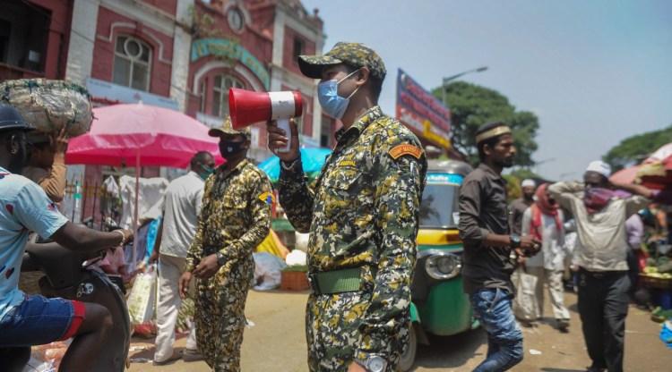 Bengaluru: BBMP municipality marshals make announcements on a microphone for social distancing and wearing of masks, amid spread of coronavirus, at a city market in Bengaluru, Tuesday, April 26, 2022. (PTI Photo)