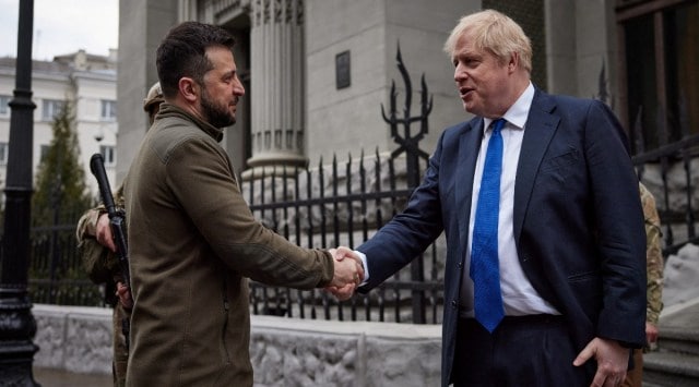 Ukraine's President Volodymyr Zelenskiy and British Prime Minister Boris Johnson shake hands after walking in central Kyiv. (Reuters)