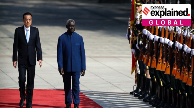 Chinese Premier Li Keqiang, left, and Solomon Islands Prime Minister Manasseh Sogavare review an honor guard during a welcome ceremony at the Great Hall of the People in Beijing, Wednesday, Oct. 9, 2019. (AP Photo/Mark Schiefelbein)