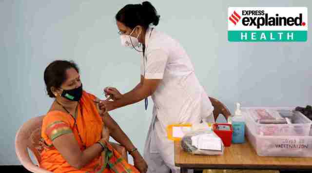 A health worker vaccinates a beneficiary in Navi Mumbai. (Express Photo: Amit Chakravarty)