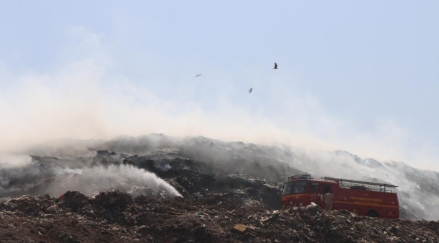 Firemen try to douse the fire at Dadumajra dumping ground on Wednesday. (Express photo by Jasbir Malhi)
