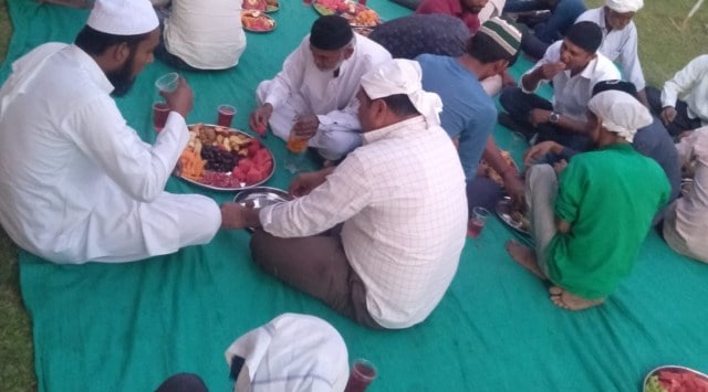 Muslim rozedars break their fast after offering namaz inside Varanda Vir Maharaj temple premises in Dalvana village. (Express Photo)