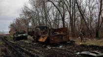 Recaptured Ukrainian village left with wrecked tanks, bodies and questions