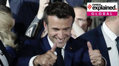 French President Emmanuel Macron thumbs up after reports of his reelection Sunday, April 24, 2022 in Paris. (AP Photo/Lewis Joly)