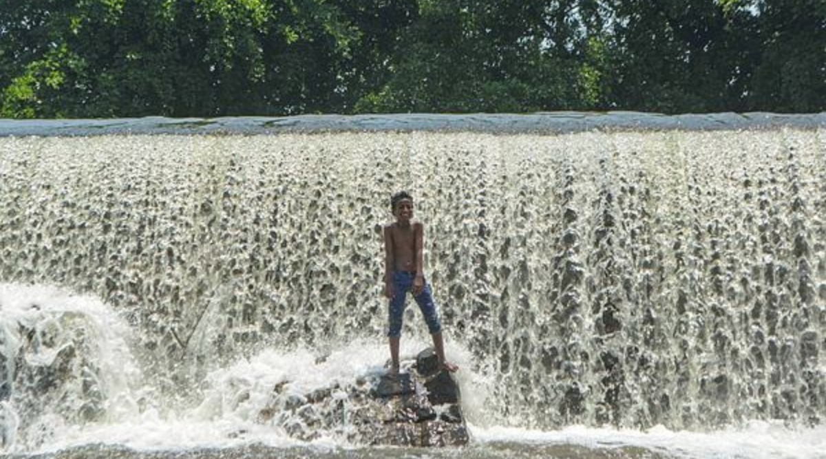 A boy reacts as he cools off in the Khodashi dam, during a hot summer day in Karad, Friday, April 29, 2022. (PTI Photo)