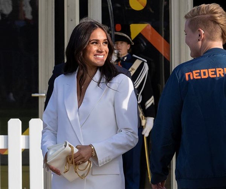 Meghan Markle, Meghan Markle news, Meghan Markle in Europe, Meghan Markle fashion, Meghan Markle back in Europe, Meghan Markle Invictus Games, Meghan Markle Valentino, Meghan Markle pantsuit, indian express news