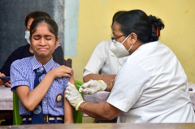 A healthworker administers a dose of Covid-19 vaccine to a student in the age group of 12-14 years, in Guwahati. (PTI)