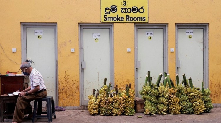 A banana vendor makes final balances on a book at a wholesale market, amid the country's economic crisis in Colombo, Wednesday (REUTERS)