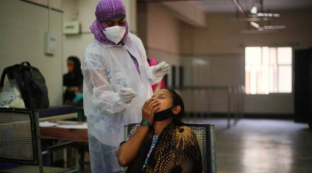 Covid testing in progress at a civic-run clinic in Mumbai. (Express photo: Amit Chakravarty)