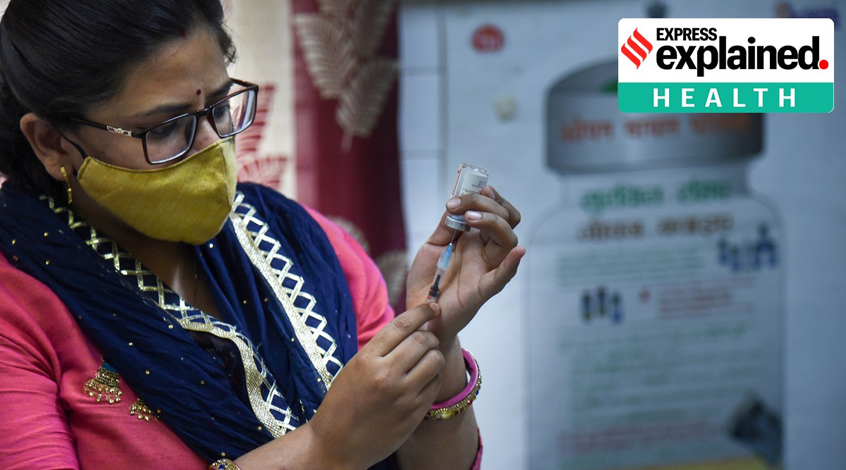 A healthworker fills a syringe with a dose of Covid-19 vaccine before administering it to a beneficiary, in New Delhi, Saturday, April 23, 2022. (PTI Photo/Shahbaz Khan) 