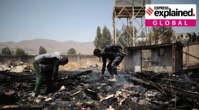 Yemeni police inspect a site of Saudi-led airstrikes targeting two houses in Sanaa, Yemen, Saturday, March 26, 2022. (AP Photo/Hani Mohammed)