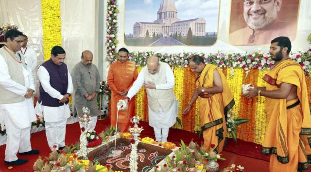 Union Home Minister Amit Shah lays the foundation stone of a 400 bedded multi-speciality hospital, at Sathya Sai Grama, in Muddenahalli. (PTI Photo)