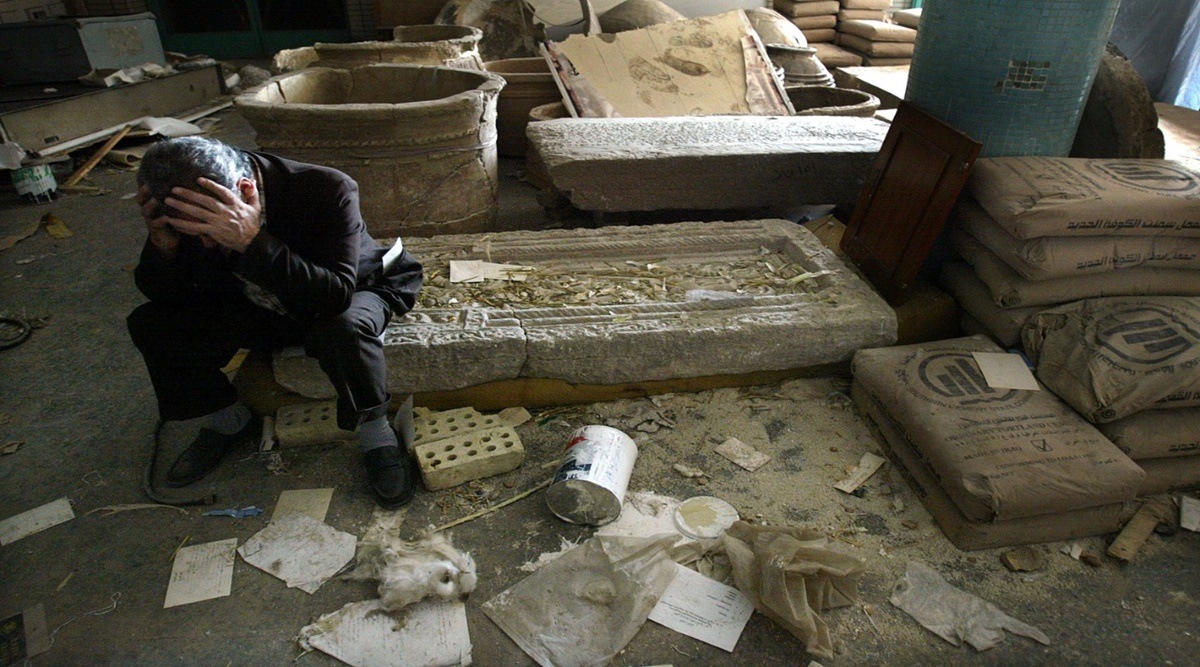 Iraqi National Museum Deputy Director Mushin Hasan next to destroyed artifacts in Baghdad, in April 2003. Photographer: Mario Tama/Getty Images