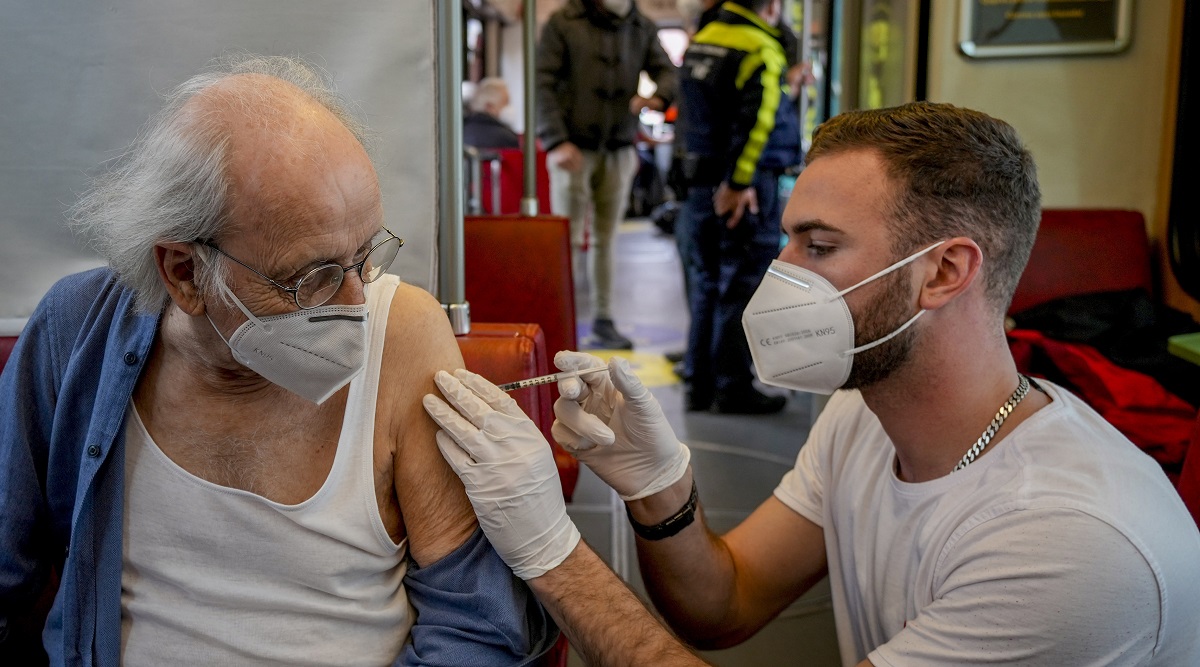 File photo shows a 85-year-old man receiving a booster vaccination in the so called "vaccination express" tram in central Frankfurt. (AP)