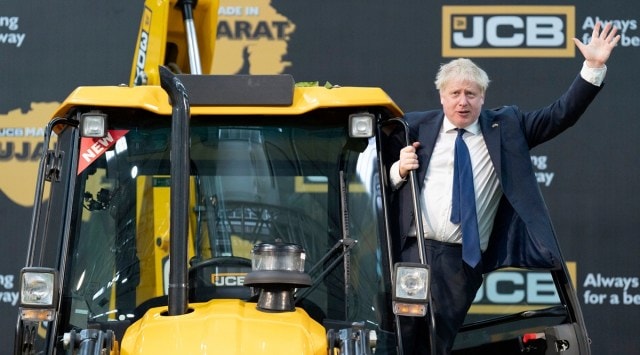 Britain's Prime Minister Boris Johnson climbs onto a JCB at the new JCB Factory in Vadodara, Gujarat, April 21, 2022. (AP/PTI)