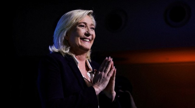 File photo of Marine Le Pen, leader of French far-right National Rally (Rassemblement National) party and candidate for the 2022 French presidential election, gesturing as she appears on stage after partial results in the first round of the 2022 French presidential election are announced in Paris. (Reuters)