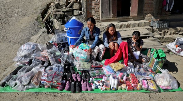 Refugees who fled from Myanmar, sell goods at a roadside stall at Farkawn village near the India-Myanmar border, in the northeastern state of Mizoram, India, November 22, 2021. (REUTERS/Rupak De Chowdhuri)