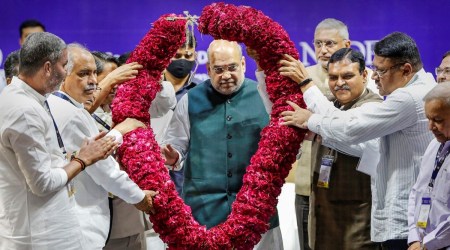 Union Home Minister Amit Shah being garlanded during the golden jubilee celebration of National Cooperative Dairy Federation of India, in Gandhinagar, Sunday (PTI)