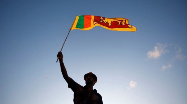 A demonstrator holds a Sri Lankan national flag during a protest against President Gotabaya Rajapaksa, near the Presidential Secretariat, in Colombo. (Reuters, file)