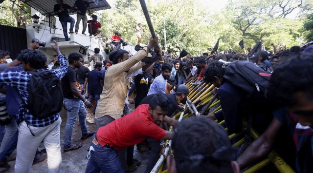 Demonstrators pull barricades outside the Sri Lankan Prime Minister Mahinda Rajapaksa's residence during the protest, amid the country's economic crisis, in Colombo. (Reuters)